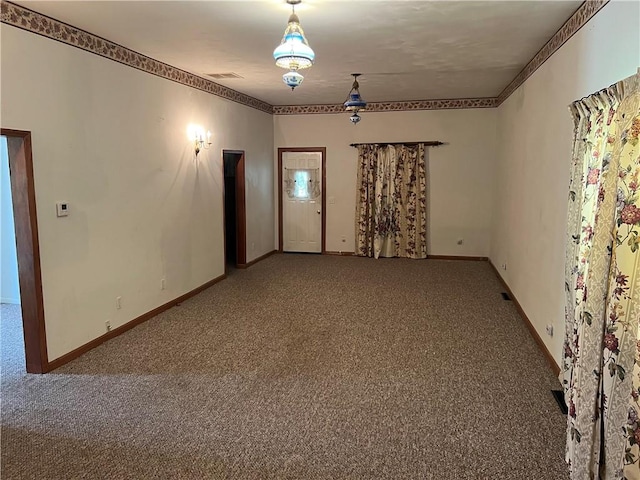 409 S Buckeye St, Iola, KS 66749 - carpeted empty room with baseboards