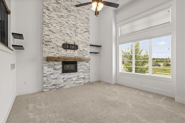 29702 W 195th St, Gardner, KS 66030 - unfurnished living room featuring a ceiling fan, carpet, a fireplace, and a towering ceiling