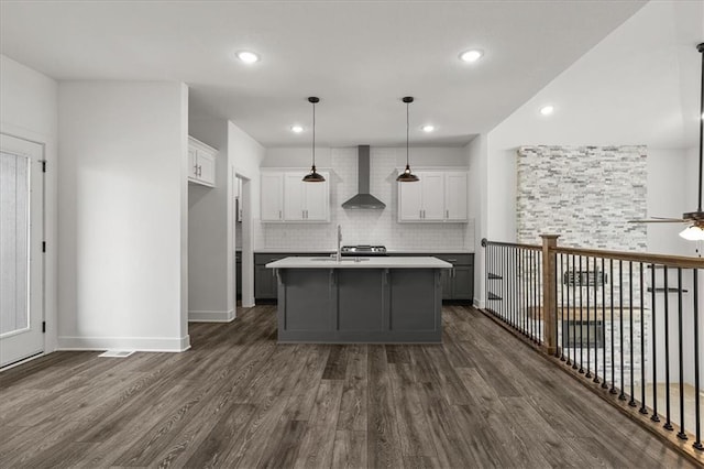 29702 W 195th St, Gardner, KS 66030 - kitchen with wall chimney range hood, dark wood finished floors, white cabinets, ceiling fan, and light countertops