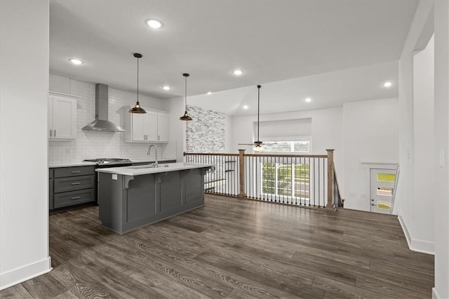 29702 W 195th St, Gardner, KS 66030 - kitchen featuring wall chimney range hood, a ceiling fan, gray cabinetry, dark wood-style floors, and light countertops