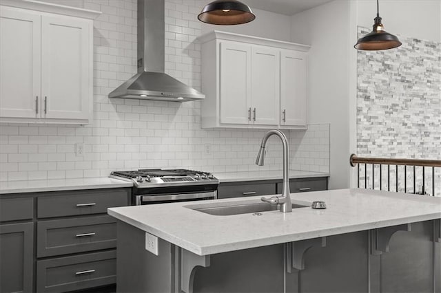 29702 W 195th St, Gardner, KS 66030 - kitchen featuring wall chimney exhaust hood, stainless steel range with gas stovetop, gray cabinetry, and decorative backsplash