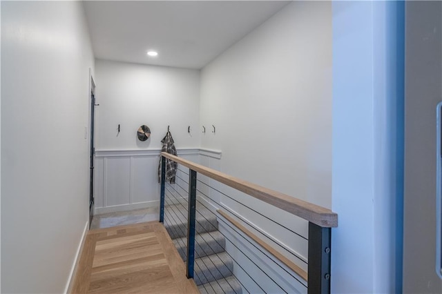 2031 N 75th St, Kansas City, KS 66109 - staircase with wood finished floors, a wainscoted wall, and recessed lighting