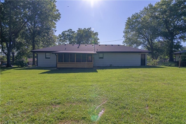 2031 N 75th St, Kansas City, KS 66109 - rear view of house featuring a yard and a sunroom