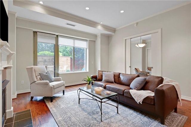 4900 Central St Unit 104, Kansas City, MO 64112 - living room with ornamental molding, wood finished floors, a fireplace, and recessed lighting