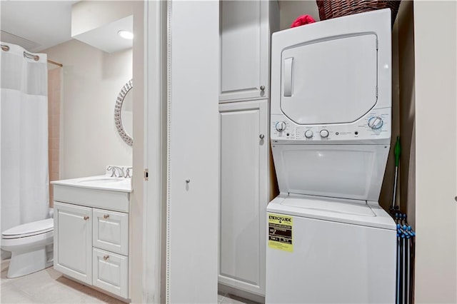 4900 Central St Unit 104, Kansas City, MO 64112 - laundry room with stacked washer / drying machine