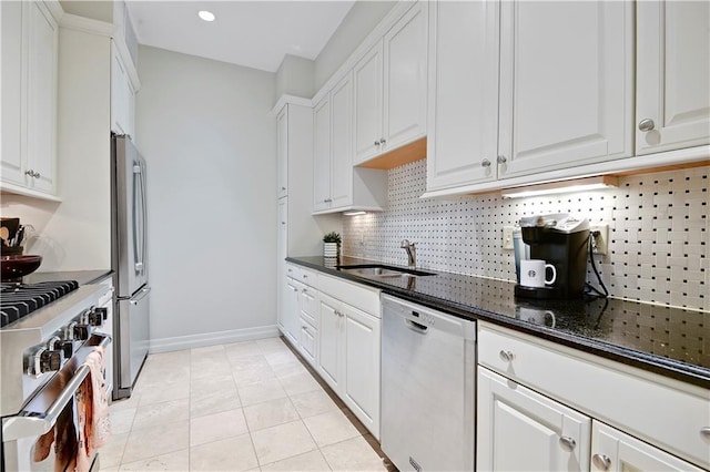 4900 Central St Unit 104, Kansas City, MO 64112 - kitchen with appliances with stainless steel finishes, backsplash, white cabinetry, dark stone counters, and recessed lighting