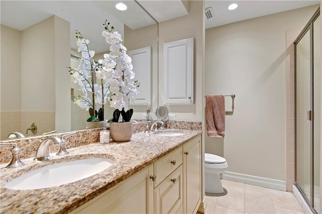 4900 Central St Unit 104, Kansas City, MO 64112 - full bathroom featuring a stall shower, double vanity, and tile patterned floors