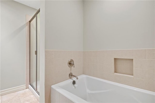4900 Central St Unit 104, Kansas City, MO 64112 - full bathroom with a stall shower and a bath