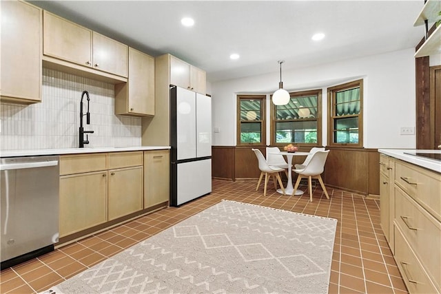 7100 Antioch Rd, Merriam, KS 66204 - kitchen with dishwasher, freestanding refrigerator, light countertops, a wainscoted wall, and decorative backsplash