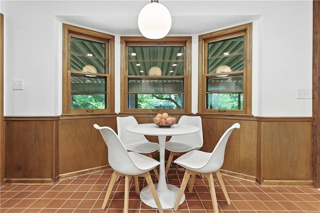7100 Antioch Rd, Merriam, KS 66204 - dining room with wainscoting, wood walls, built in shelves, and tile patterned floors