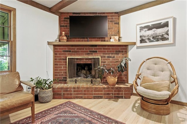 7100 Antioch Rd, Merriam, KS 66204 - living area with wood finished floors, beam ceiling, and a fireplace