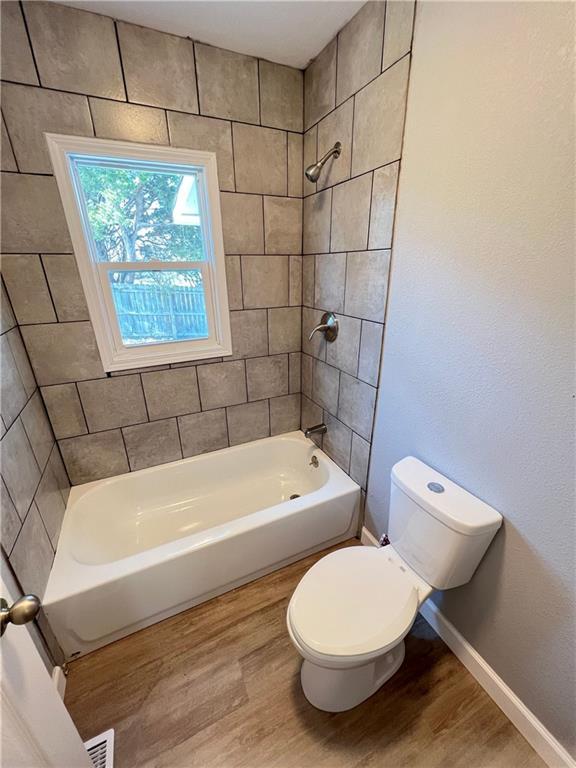 11117 E 15th St S, Independence, MO 64052 - bathroom featuring wood finished floors and  shower combination