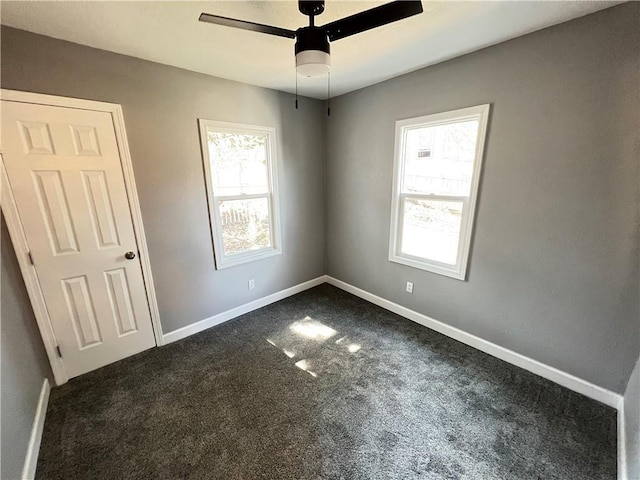 11117 E 15th St S, Independence, MO 64052 - empty room featuring dark carpet and ceiling fan
