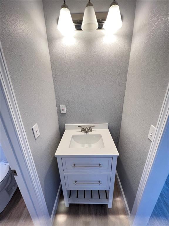 11117 E 15th St S, Independence, MO 64052 - bathroom with vanity, wood finished floors, and a textured wall