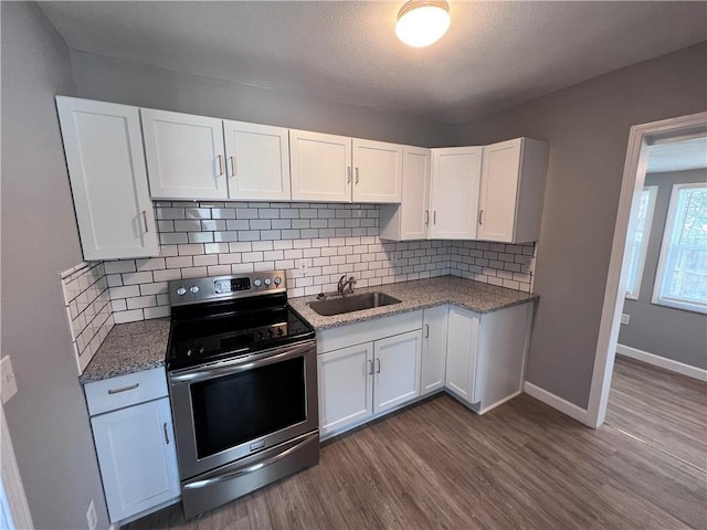 11117 E 15th St S, Independence, MO 64052 - kitchen featuring stainless steel range with electric cooktop, dark wood-style floors, and white cabinets
