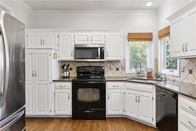 14162 W 150th Ct, Olathe, KS 66062 - kitchen featuring black appliances, white cabinetry, ornamental molding, dark wood-style flooring, and dark stone counters