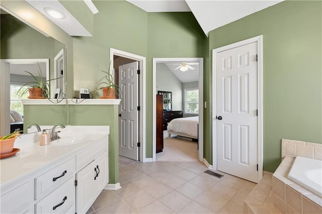 14162 W 150th Ct, Olathe, KS 66062 - bathroom with connected bathroom, lofted ceiling, vanity, a garden tub, and a ceiling fan