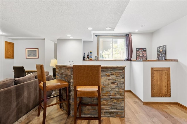 14162 W 150th Ct, Olathe, KS 66062 - indoor wet bar featuring light wood-style floors, a textured ceiling, and recessed lighting