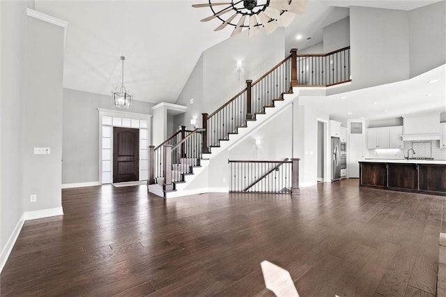 704 SW Admiral Byrd Dr, Lees Summit, MO 64082 - foyer entrance featuring high vaulted ceiling, dark wood-style floors, ceiling fan, stairway, and recessed lighting