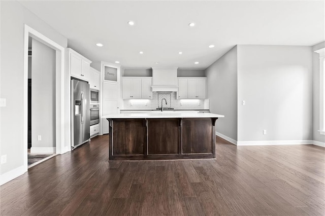704 SW Admiral Byrd Dr, Lees Summit, MO 64082 - kitchen featuring appliances with stainless steel finishes, light countertops, dark wood finished floors, backsplash, and white cabinetry