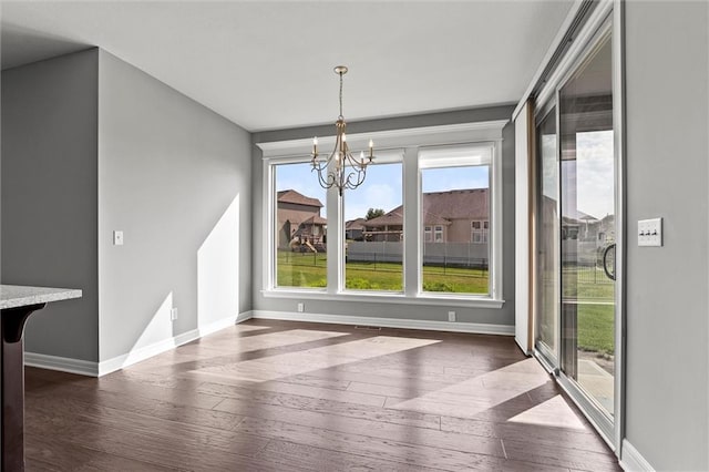 704 SW Admiral Byrd Dr, Lees Summit, MO 64082 - unfurnished dining area with dark wood-style flooring and a chandelier