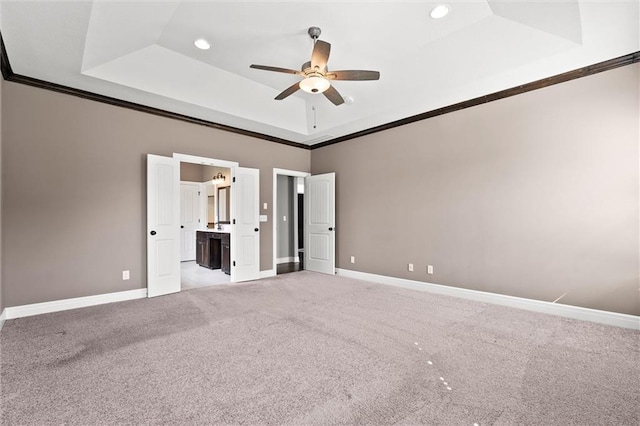 704 SW Admiral Byrd Dr, Lees Summit, MO 64082 - unfurnished bedroom with a tray ceiling, crown molding, light carpet, recessed lighting, and connected bathroom