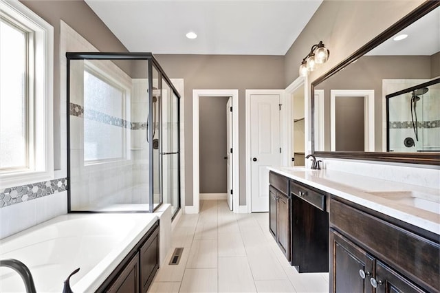 704 SW Admiral Byrd Dr, Lees Summit, MO 64082 - full bathroom with a shower stall, double vanity, a garden tub, and tile patterned flooring