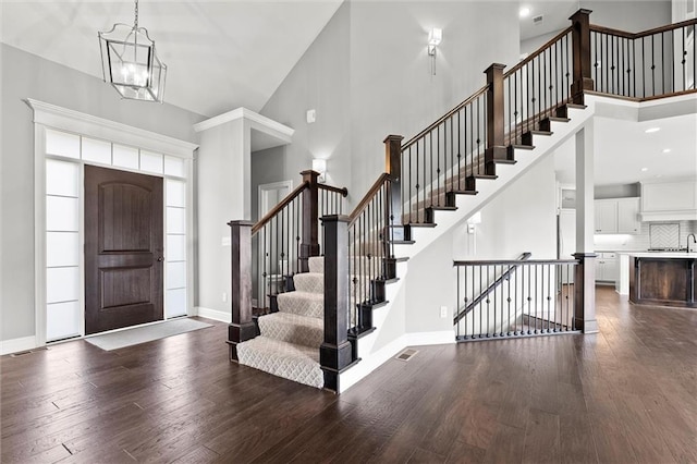 704 SW Admiral Byrd Dr, Lees Summit, MO 64082 - foyer featuring dark wood-style floors, a chandelier, stairs, and a high ceiling