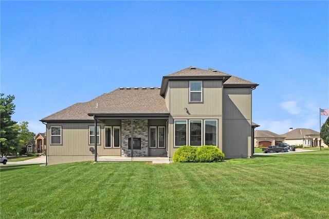 704 SW Admiral Byrd Dr, Lees Summit, MO 64082 - back of house with a lawn, a patio area, and a shingled roof