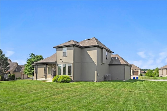 704 SW Admiral Byrd Dr, Lees Summit, MO 64082 - back of property featuring a lawn and a shingled roof