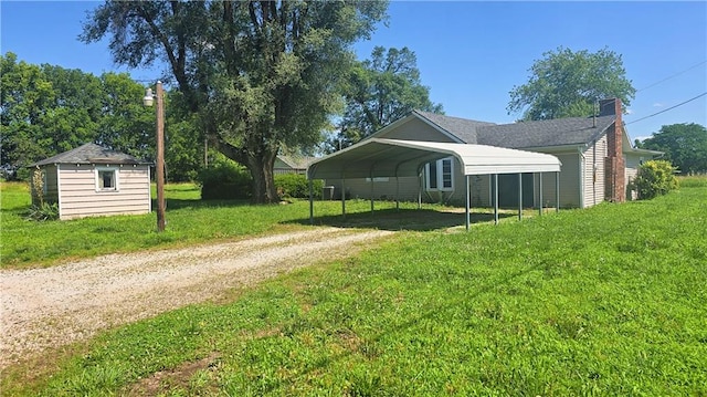 1443 215th St, Fort Scott, KS 66701 - view of home's exterior featuring driveway, a carport, a yard, and a chimney