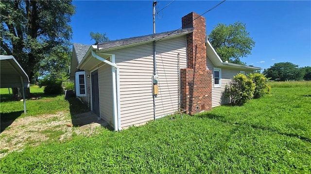 1443 215th St, Fort Scott, KS 66701 - view of side of property featuring a chimney and a yard