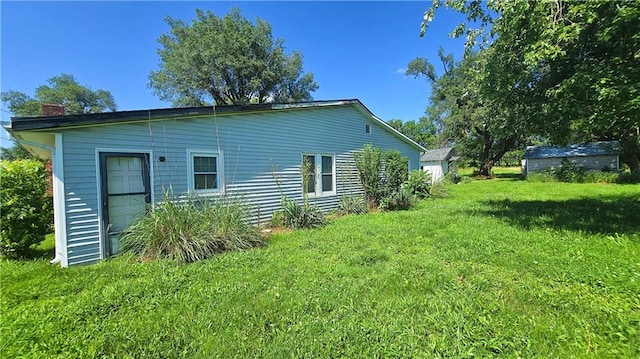 1443 215th St, Fort Scott, KS 66701 - view of home's exterior with a yard and a chimney