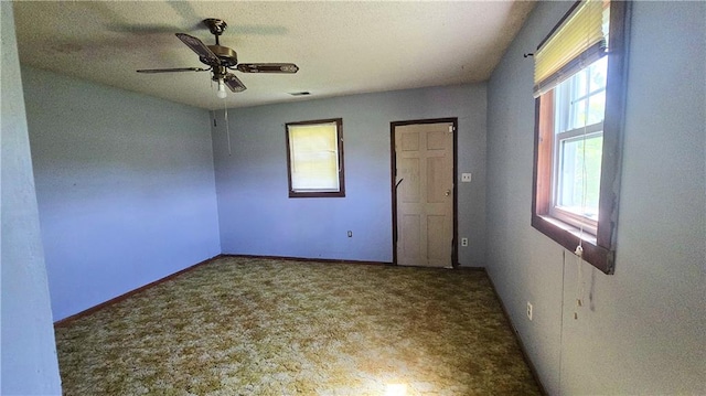 1443 215th St, Fort Scott, KS 66701 - unfurnished bedroom with multiple windows, carpet flooring, and a ceiling fan