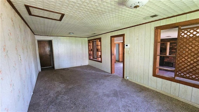 1443 215th St, Fort Scott, KS 66701 - carpeted spare room with wooden walls and crown molding