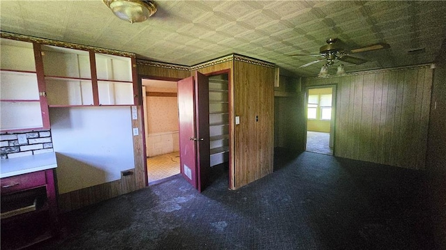 1443 215th St, Fort Scott, KS 66701 - hallway with wooden walls and carpet floors