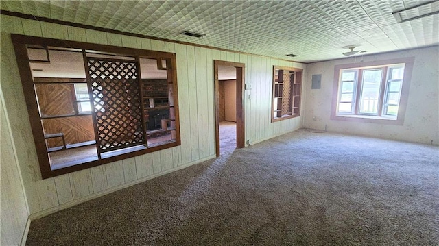 1443 215th St, Fort Scott, KS 66701 - carpeted empty room with wooden walls