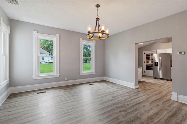 306 W 4th St, Cameron, MO 64429 - unfurnished room with a chandelier and light wood-style floors