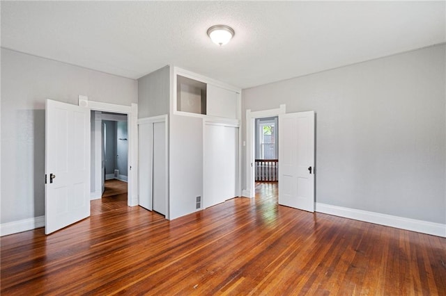 306 W 4th St, Cameron, MO 64429 - unfurnished bedroom featuring wood finished floors and a closet