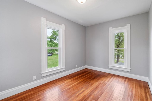 306 W 4th St, Cameron, MO 64429 - empty room featuring plenty of natural light and hardwood / wood-style floors