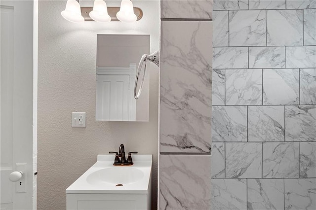 306 W 4th St, Cameron, MO 64429 - bathroom with vanity and a textured wall