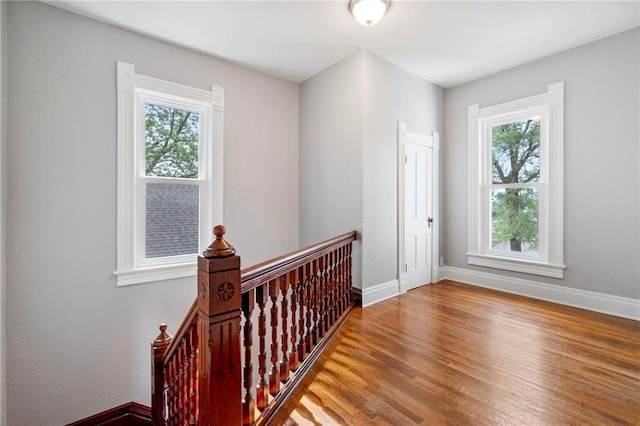 306 W 4th St, Cameron, MO 64429 - hall featuring an upstairs landing, plenty of natural light, and wood finished floors