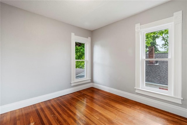 306 W 4th St, Cameron, MO 64429 - spare room featuring healthy amount of natural light and wood finished floors
