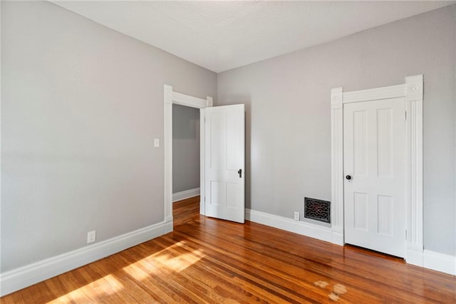 306 W 4th St, Cameron, MO 64429 - unfurnished bedroom with baseboards and wood finished floors