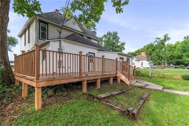 306 W 4th St, Cameron, MO 64429 - rear view of house with a shingled roof and a wooden deck