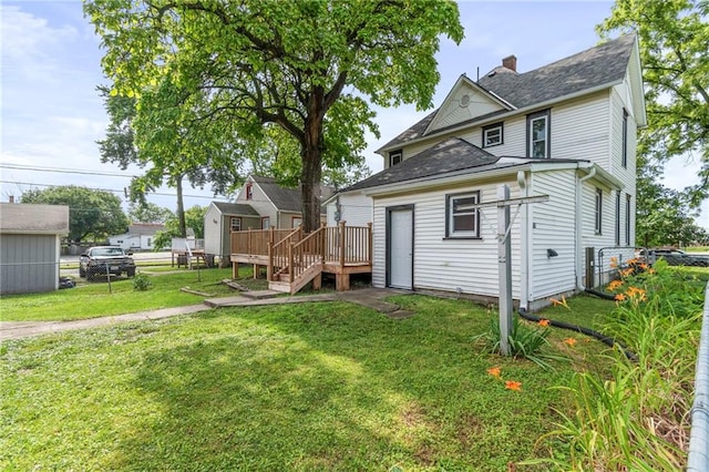 306 W 4th St, Cameron, MO 64429 - back of house with a deck, a chimney, a shingled roof, and stairs