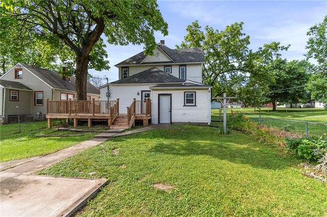 306 W 4th St, Cameron, MO 64429 - back of house featuring a wooden deck, a fenced backyard, and a chimney