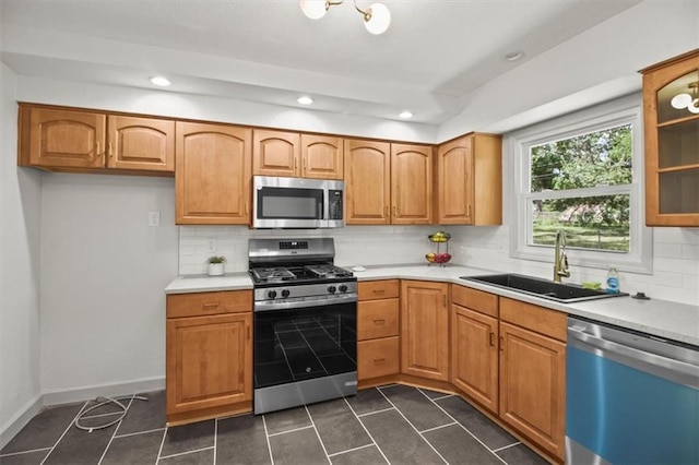 5015 S Marion Ave, Independence, MO 64055 - kitchen with appliances with stainless steel finishes, dark tile patterned flooring, backsplash, light countertops, and recessed lighting