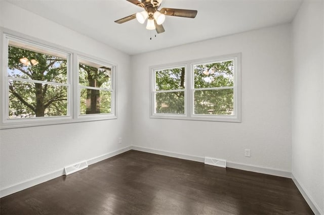 5015 S Marion Ave, Independence, MO 64055 - empty room with a ceiling fan and dark wood-style flooring