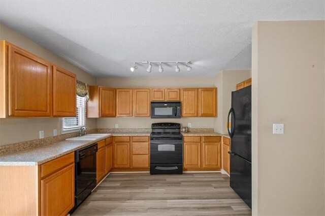 802 W 39th St N, Independence, MO 64050 - kitchen with black appliances, light countertops, and light wood-style floors